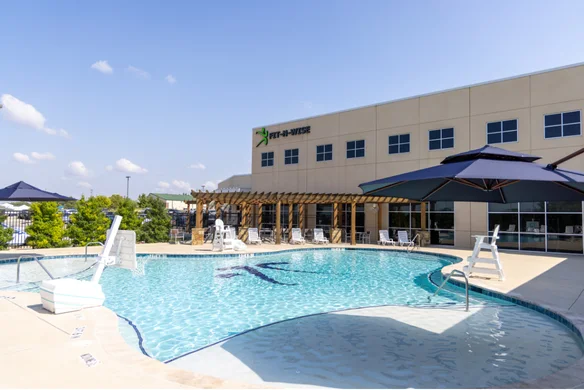 Outdoor leisure pool and patio at Fit-N-Wise
