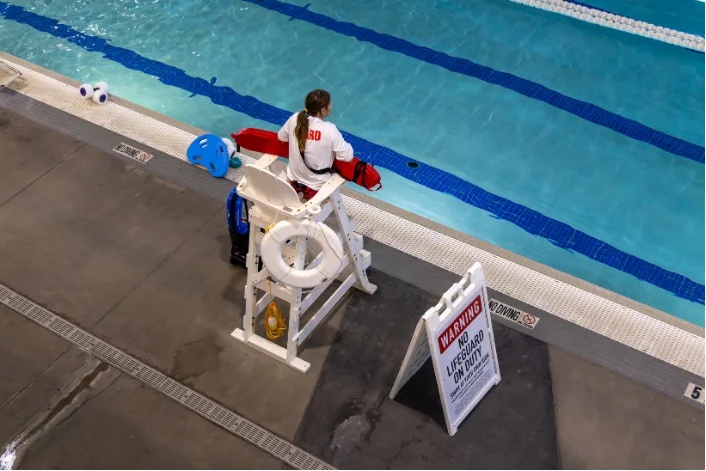 Lifeguard on duty beside the lap pool